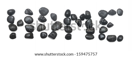 The word home written using black stones isolated on white. 