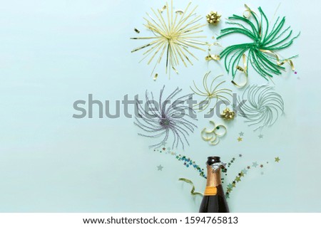 Fireworks made of decorations coming out of a champagne bottle