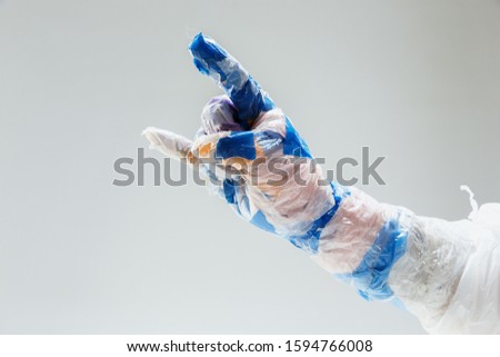Big plastic hand made of garbage isolated on white studio background. The result of polymers overusing and overproduction. Ecology problems, pollution, recycling. It's getting dangerous for humanity.