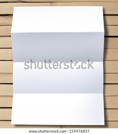 Simple folded white blank paper on background.