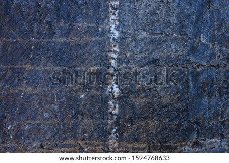 Background of a multicolored rock with a natural white line in the middle dividing it into two parts
