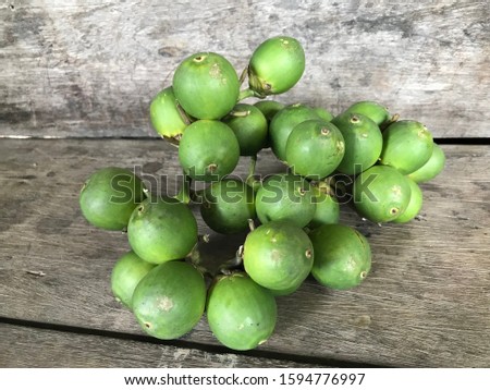 Close up Betel nut on wooden background.