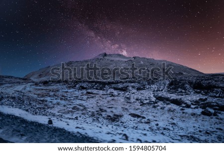 stars shine behind the mountain in winter
