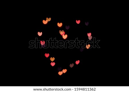 heart-shaped bokeh on a black background copy space.