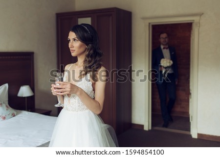 Wedding day. Bride waiting for groom in room.