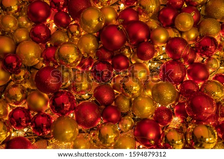 Close up high resolution amazing new year decorative arrangement with red yellow gold decoration balls with incredible lights underneath