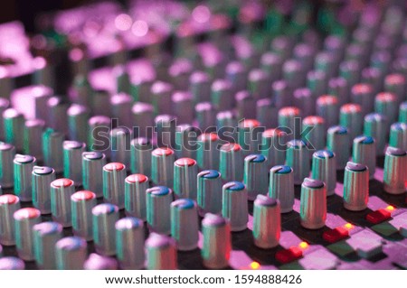 View of music mixer in concert, filled with lights