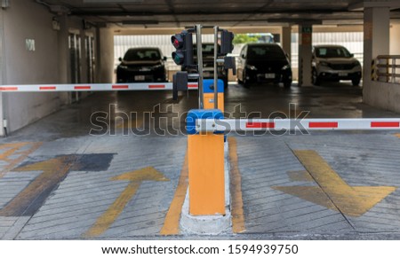 car park automatic entry system.Security system for building access - barrier gate stop with toll booth, traffic cones.