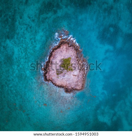 Aerial photo of deserted rocky island in turquoise water