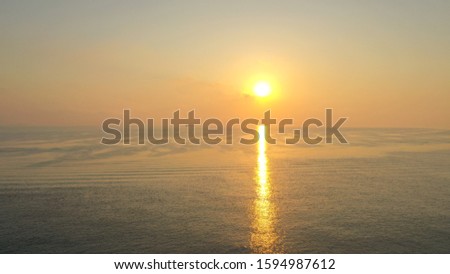 Aerial view with drone of a colorful morning sunrise over the big ocean sea with nice reflection line