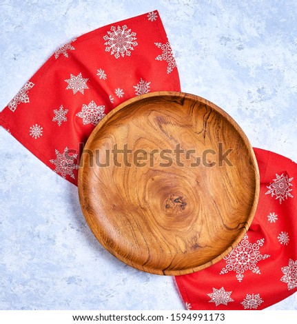 Christmas composition. Christmas gift, knitted blanket, pine cones, fir branches on wooden white background. Flat lay, top view, copy space