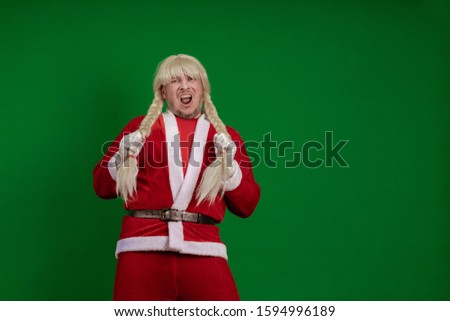 Emotional Santa Claus with long braid hairstyle grimaces and poses on a green chrome background