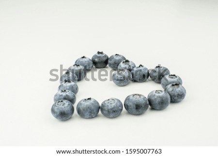 fresh blueberry heart shape on white background