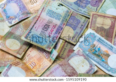 selective focus of vintage/old Indian currency rupees hundred,fifty,ten,five,two and one notes arranged in random manner. Royalty-Free Stock Photo #1595109190