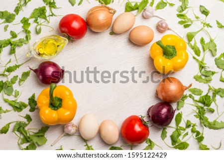 A set of vegetables for a healthy diet, yellow and red peppers, tomatoes, onions, garlic. Top view, white background. There is a place for text
