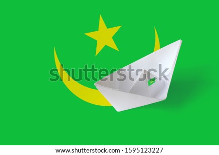 Mauritania flag depicted on paper origami ship closeup. Handmade arts concept
