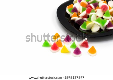 Gummy sweeties jelly on a black plate isolated on white background. and Copy space.