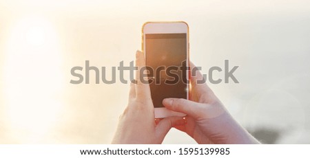 Girl photographs the sunset on the phone. Banner. text field. Text copy