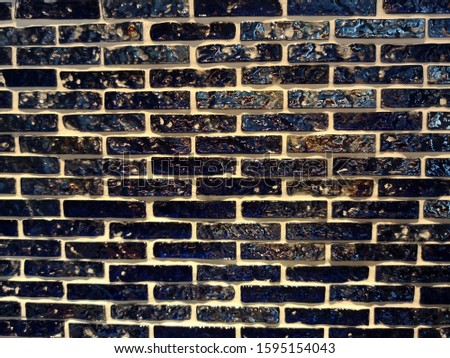 A side view of a black brick block wall