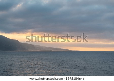 A cloudy sunset over the Atlantic Ocean in Puerto de la Cruz, Tenerife, Spain