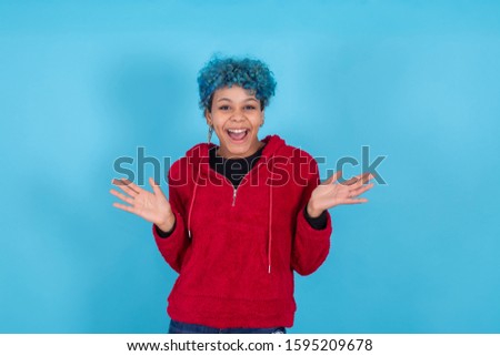 young woman smiling isolated on blue background with casual style