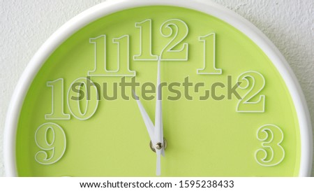 A wall clock showing time at eleven o'clock