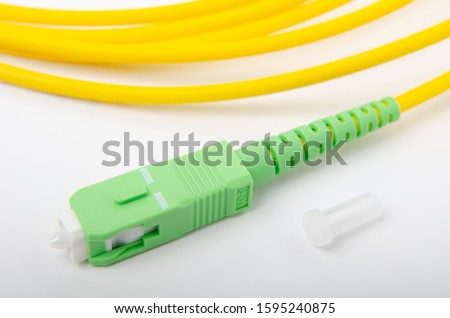 Optical SC green connector on an isolated background close-up, for connecting to the Internet, television or local area network, GPON Royalty-Free Stock Photo #1595240875