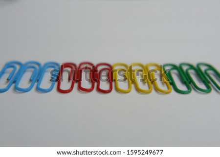 color paper clip on white background. macro focus