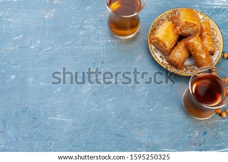 Cup of hot tea and a plate of turkish desserts