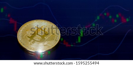 Golden Bit coins place on stock graph background.- Digital currency - Cryptocurrency