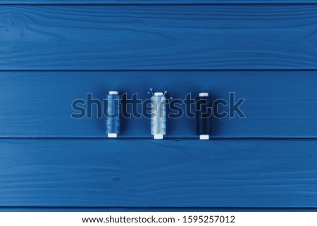 Tayloring accessories on classic blue background, top view