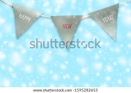 Triangular flags on a rope. Blue background. Christmas background. Congratulatory background.