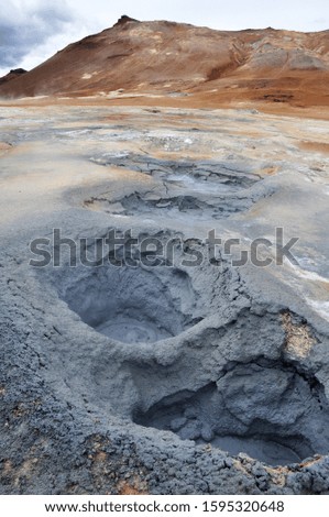 Hverir geothermal area in North Iceland with geothermal fields of bubbling mud pools, hissing fumaroles and sticky red soil