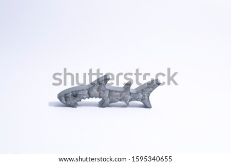 
Shark-shaped aluminum bottle opener. Opener on a white background.