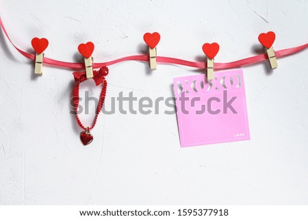 Valentines day concept. Red hearts and clothespins. White background. Top view. Space for text