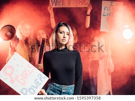 young caucasian feminist woman holding poster fighting for female rights isolated in smoky space, call for giving rights for women . freedom, feminism concept