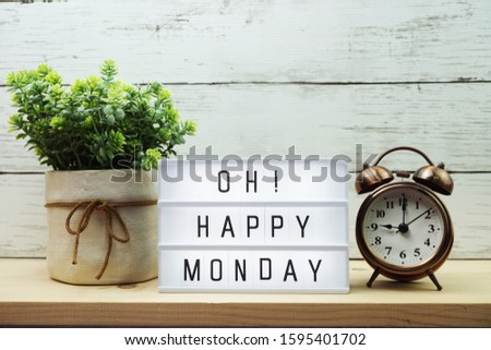 Happy Monday light box alphabet wording on wooden background