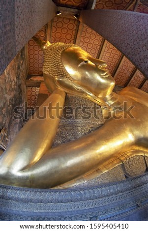 Golden top view closeup picture of Buddha statue. Buddha's face