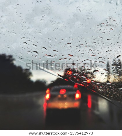 close up photo of raindrops on the windshield
