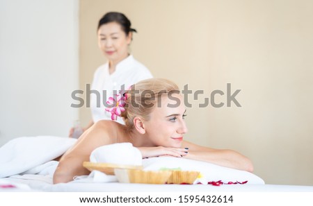 Foreign woman are happy and relaxed with Thai massage by a professional Thai masseuse. Oil massage is one of the world famous relaxation. (call Nuad Thai, traditional Thai massage ) Royalty-Free Stock Photo #1595432614
