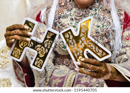 Moroccan bride. She holds the letter K and H., symbolizing the names of the newlyweds