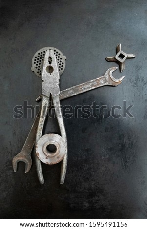 Repair tools form a symbolic composition. Pliers creative. Metal creative. Steel tools decor. Hands outstretched. Fake saint. He speaks his ideas.