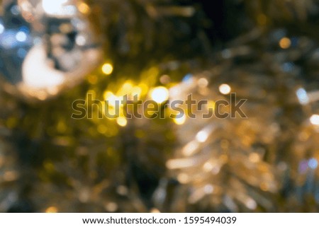decorate the yellow Christmas tree on a blurred abstract background and bokeh.