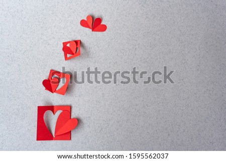 Red heart border background Romantic Valentines in love sweet couples. Red paper hearts on grey textured paper sumple backgrounds. Love and Valentine's day concept.