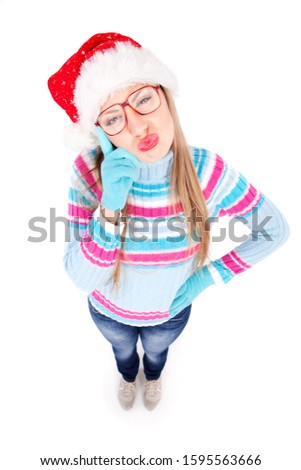 Funny young girl making faces. She is standing isolated on white background 