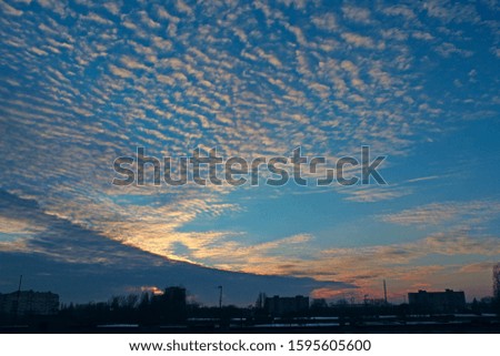 sunset above multistory house. Evening cityscape. City landscape. Dusk in town. Twilight with vermilion sunset. Big pink cloud above evening city