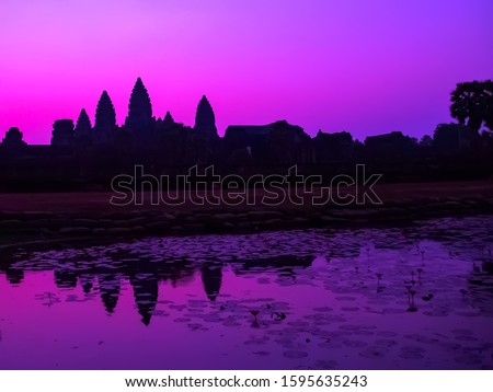 Panorama Mist sunrise tropical morning violet at lake holy Angkor Wat facade silhouette, famous destination in Cambodia. Angkor Archaeological Park khmer culture Siem Reap Cambodia
