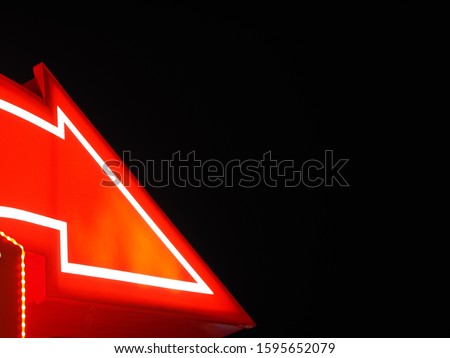 Red sign pointer signboard with white lines night black background