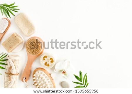 Spa Background. Natural/Organic spa cosmetics products, eco friendly bathroom accessories, palm leaves. Skincare concept on white background. Flat lay, top view