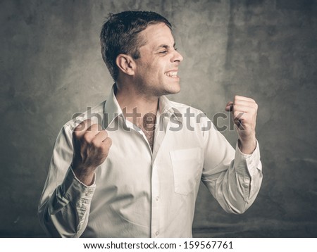 Portrait of a man with arms raised in success